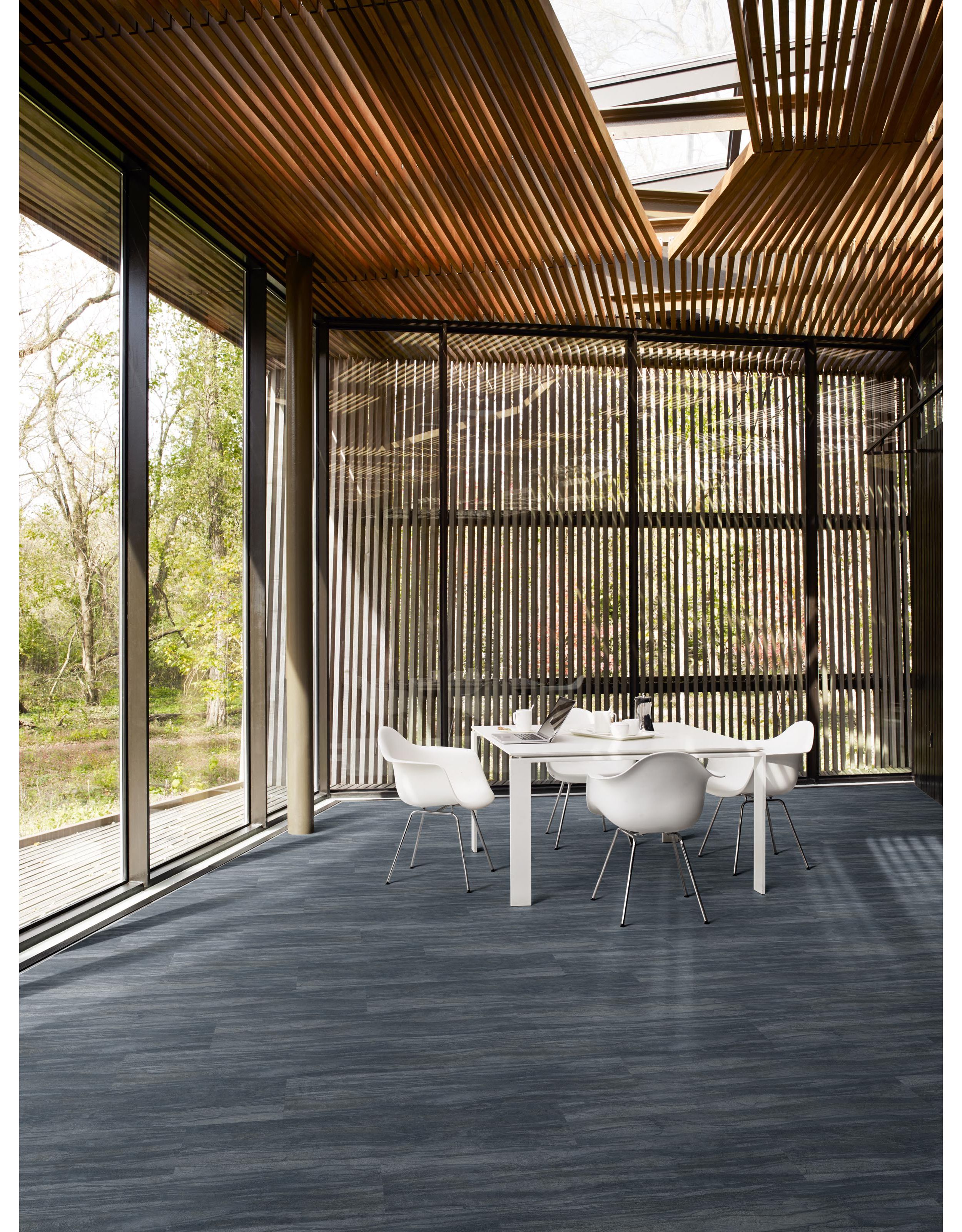 Interface Cliff LVT in open area with white table and chairs and floating wood ceiling image number 3